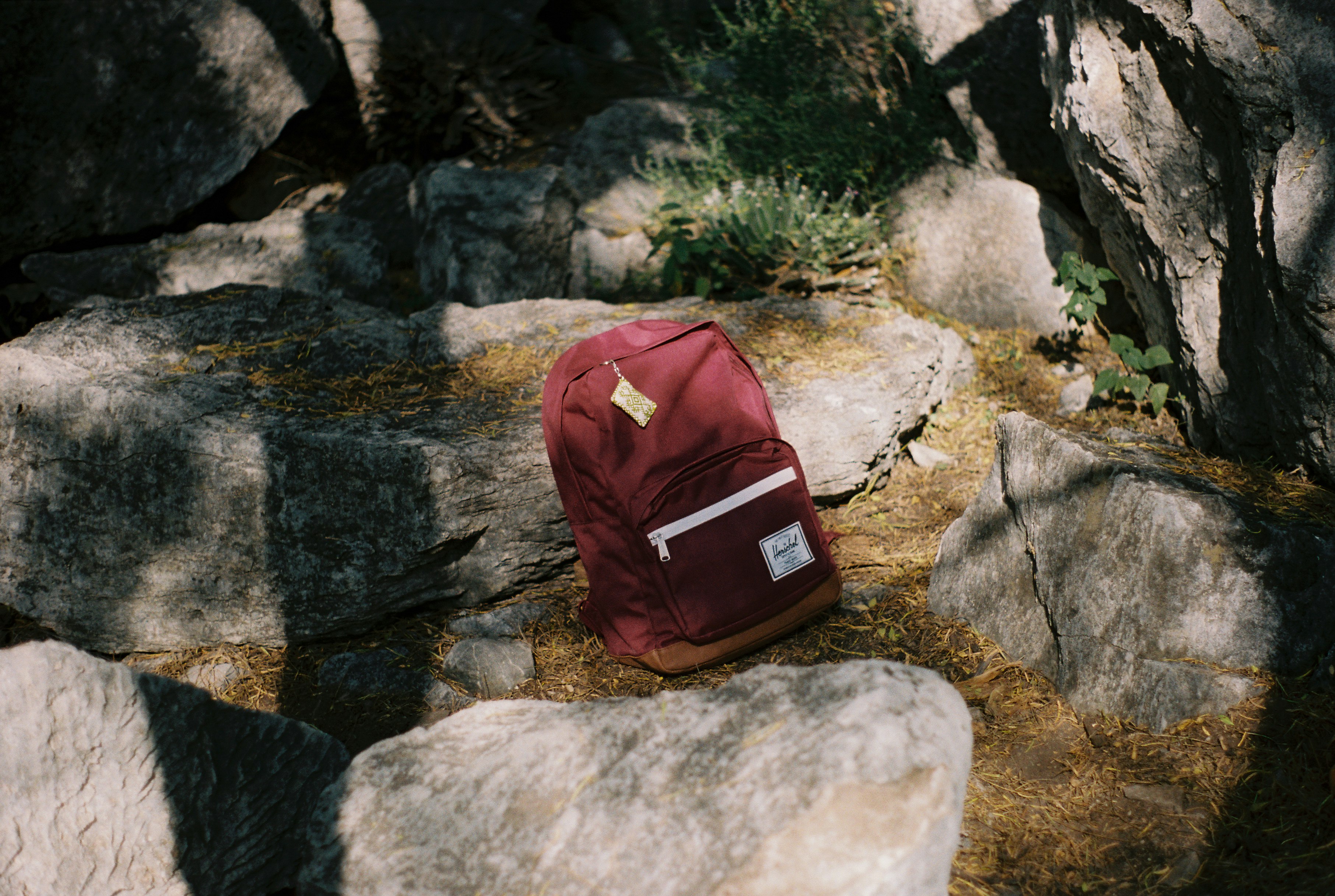 red backpack on top of rock